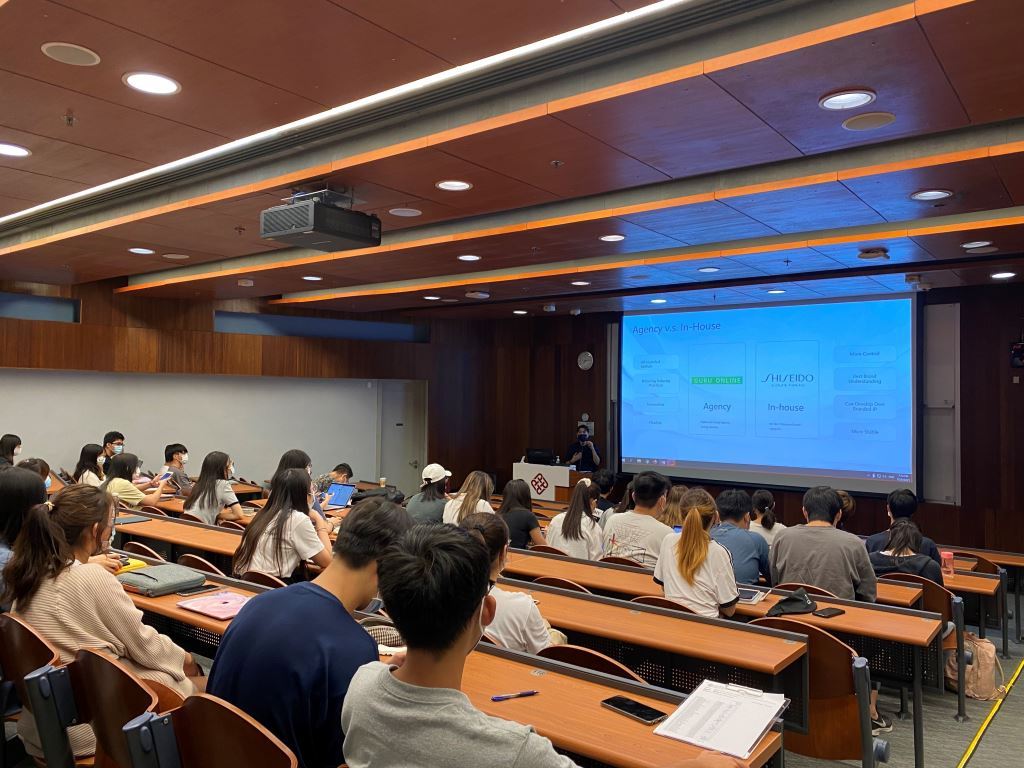 A real Hong Kong student marketing seminar with an agency-versus-in-house comparison on screen